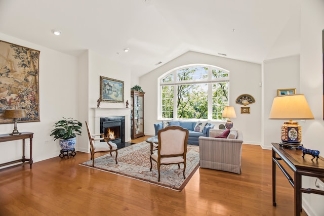 2660 Summit Dr Unit 302, Glenview, IL 60025 - living area featuring vaulted ceiling, a fireplace with flush hearth, wood finished floors, and recessed lighting
