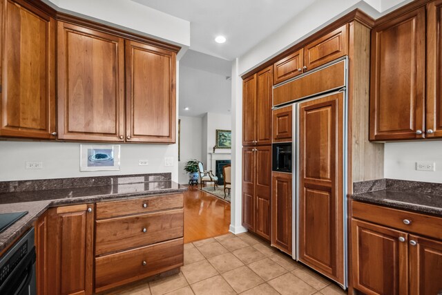 2660 Summit Dr Unit 302, Glenview, IL 60025 - kitchen featuring stainless steel appliances, under cabinet range hood, a chandelier, brown cabinetry, and recessed lighting