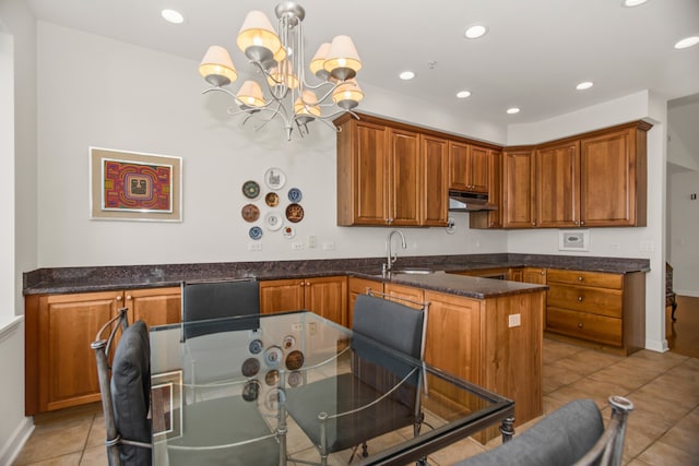 2660 Summit Dr Unit 302, Glenview, IL 60025 - kitchen with under cabinet range hood, a chandelier, brown cabinetry, recessed lighting, and light tile patterned floors