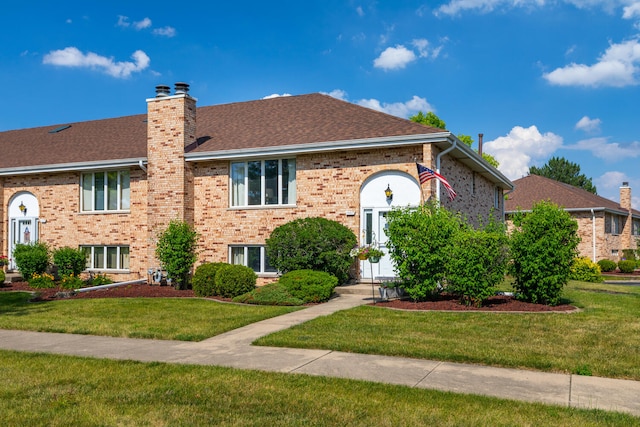 15317 S 73rd Ave Unit 8, Orland Park, IL 60462 - bi-level home with a front lawn, a chimney, a shingled roof, and brick siding