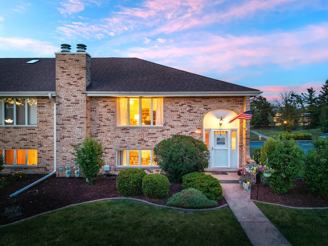 15317 S 73rd Ave Unit 8, Orland Park, IL 60462 - view of front of property with roof with shingles, brick siding, a chimney, and a front yard