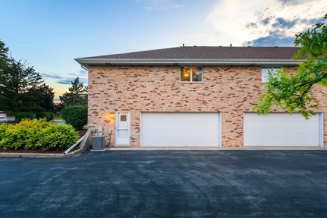 15317 S 73rd Ave Unit 8, Orland Park, IL 60462 - view of side of property featuring brick siding, driveway, and a garage