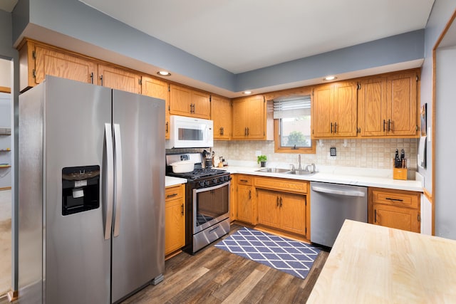 15317 S 73rd Ave Unit 8, Orland Park, IL 60462 - kitchen featuring stainless steel appliances, light countertops, dark wood-style floors, tasteful backsplash, and recessed lighting
