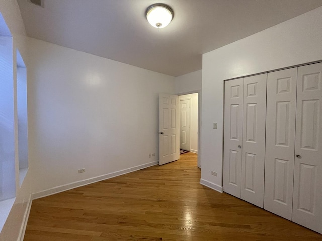 6938 S Dorchester Ave Unit 2, Chicago, IL 60637 - unfurnished bedroom with light wood-style floors and a closet