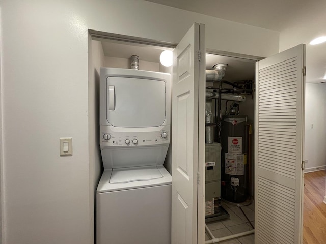 6938 S Dorchester Ave Unit 2, Chicago, IL 60637 - laundry area with water heater, stacked washing machine and dryer, and light tile patterned flooring