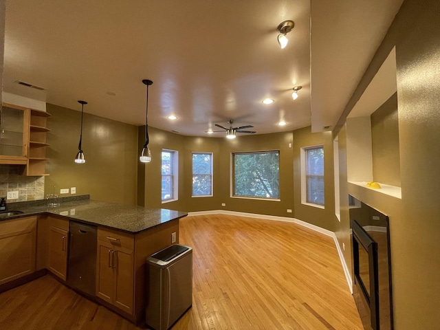 6938 S Dorchester Ave Unit 2, Chicago, IL 60637 - kitchen with stainless steel dishwasher, light wood-style floors, a peninsula, tasteful backsplash, and decorative light fixtures
