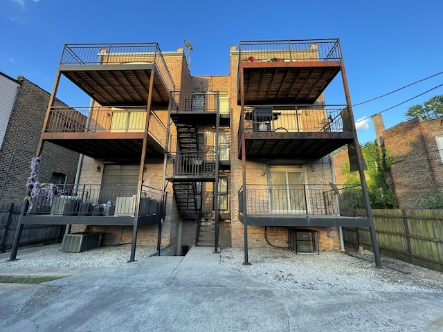 6938 S Dorchester Ave Unit 2, Chicago, IL 60637 - back of house featuring a balcony and brick siding