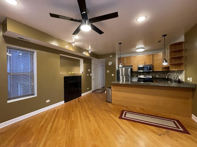 6938 S Dorchester Ave Unit 2, Chicago, IL 60637 - kitchen with stainless steel appliances, open shelves, a peninsula, light wood-style flooring, and a fireplace