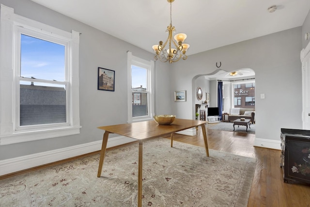 1848 W Cermak Rd Unit 3, Chicago, IL 60608 - dining space with wood finished floors, a chandelier, and arched walkways