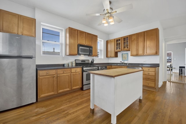 1848 W Cermak Rd Unit 3, Chicago, IL 60608 - kitchen with appliances with stainless steel finishes, butcher block counters, ceiling fan, dark wood-style floors, and healthy amount of natural light