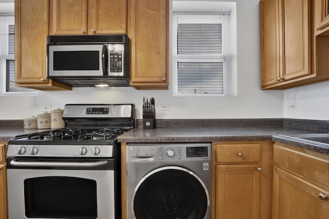 1848 W Cermak Rd Unit 3, Chicago, IL 60608 - kitchen with washer / dryer, stainless steel range with gas cooktop, and dark countertops