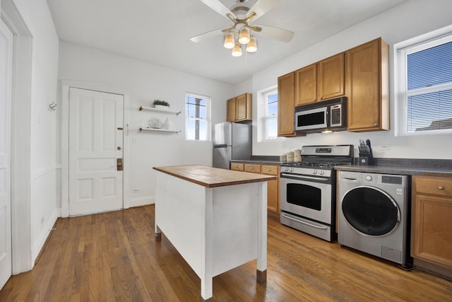 1848 W Cermak Rd Unit 3, Chicago, IL 60608 - kitchen featuring appliances with stainless steel finishes, washer / dryer, open shelves, a ceiling fan, and butcher block countertops