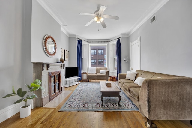 1848 W Cermak Rd Unit 3, Chicago, IL 60608 - living area with ornamental molding, wood finished floors, a ceiling fan, and a fireplace with flush hearth