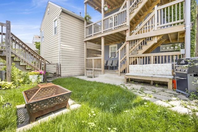1848 W Cermak Rd Unit 3, Chicago, IL 60608 - back of property with stairway, a wooden deck, and a fire pit
