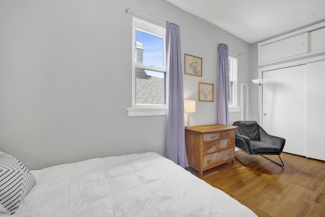 1848 W Cermak Rd Unit 3, Chicago, IL 60608 - bedroom featuring multiple windows, wood finished floors, and a closet