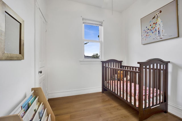 1848 W Cermak Rd Unit 3, Chicago, IL 60608 - bedroom featuring wood finished floors and a crib