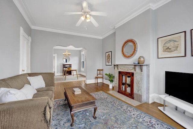 1848 W Cermak Rd Unit 3, Chicago, IL 60608 - living room featuring arched walkways, wood finished floors, ornamental molding, ceiling fan, and a chandelier