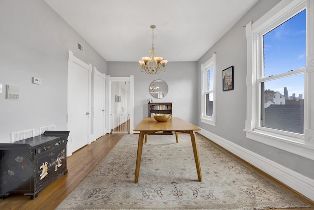1848 W Cermak Rd Unit 3, Chicago, IL 60608 - dining space featuring wood finished floors and a chandelier