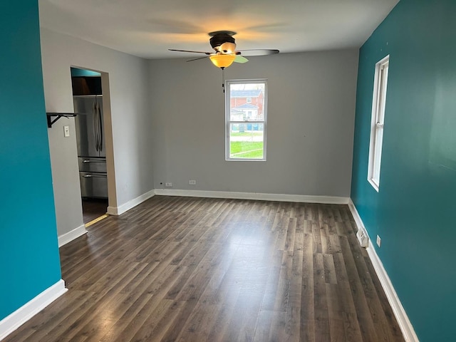 15018 Myrtle Ave, Harvey, IL 60426 - unfurnished bedroom with dark wood-style flooring, ceiling fan, and freestanding refrigerator