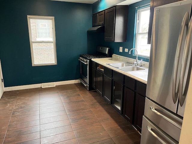 15018 Myrtle Ave, Harvey, IL 60426 - kitchen featuring appliances with stainless steel finishes, under cabinet range hood, and light countertops