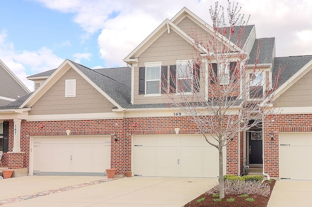 169 Waverly Ct, Bloomingdale, IL 60108 - craftsman-style home featuring roof with shingles, brick siding, concrete driveway, and a garage
