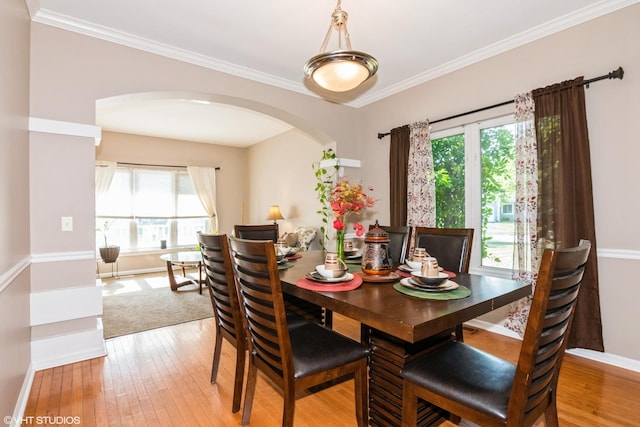 2467 Worthington Dr, Aurora, IL 60506 - dining room with arched walkways, plenty of natural light, light wood-type flooring, and ornamental molding