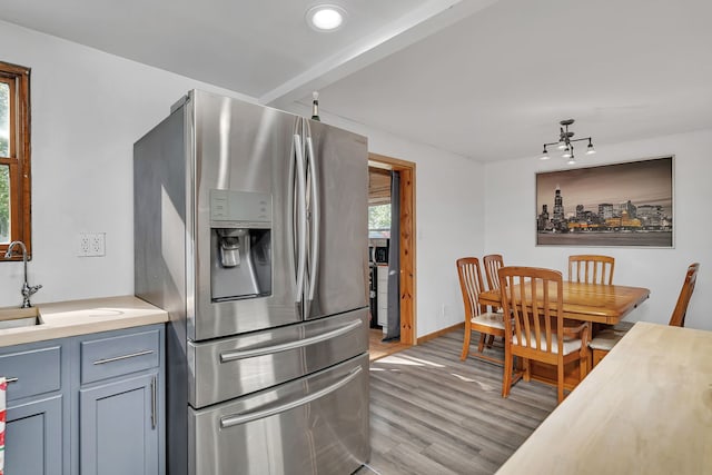 1819 Il Route 176, Crystal Lake, IL 60014 - kitchen with stainless steel refrigerator with ice dispenser, light wood-style flooring, light countertops, and rail lighting