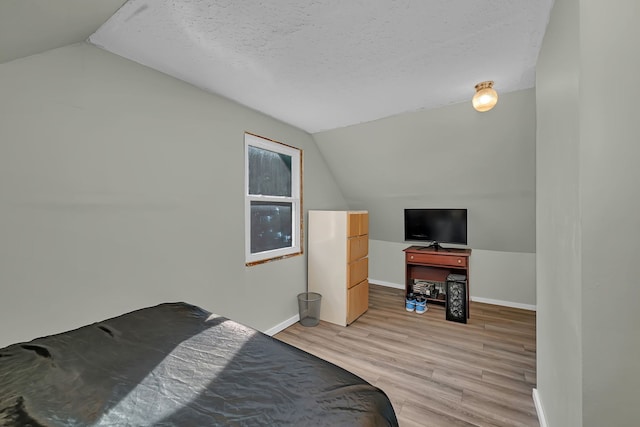 1819 Il Route 176, Crystal Lake, IL 60014 - bedroom with lofted ceiling, light wood finished floors, and a textured ceiling