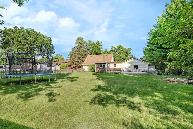 1819 Il Route 176, Crystal Lake, IL 60014 - fenced backyard featuring a trampoline and a deck