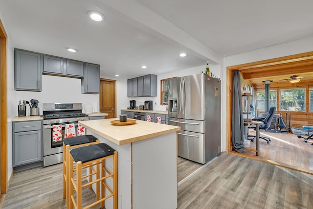 1819 Il Route 176, Crystal Lake, IL 60014 - kitchen featuring stainless steel appliances, gray cabinets, light wood-style flooring, a breakfast bar, and recessed lighting
