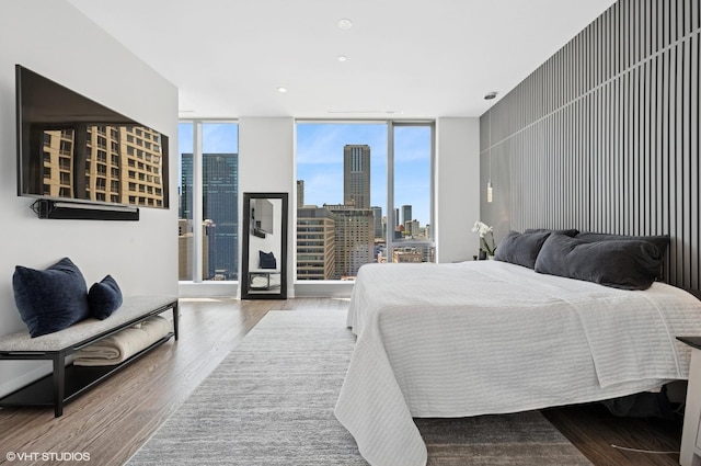 403 N Wabash Ave Unit 17C, Chicago, IL 60611 - bedroom with a view of skyline, wood finished floors, a wall of windows, access to exterior, and recessed lighting
