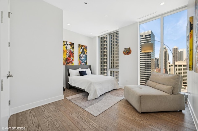 403 N Wabash Ave Unit 17C, Chicago, IL 60611 - bedroom with wood finished floors, recessed lighting, and expansive windows