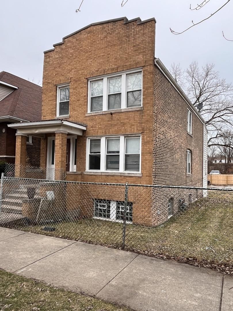 3654 E 97th St, Chicago, IL 60617 - view of front of house featuring brick siding and a fenced front yard