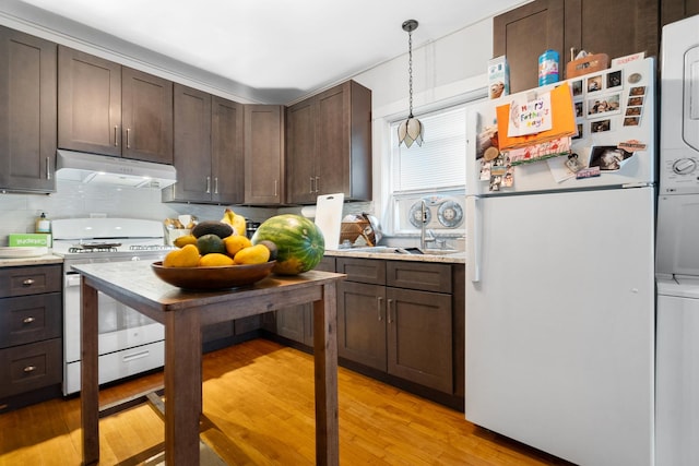5043 W Argyle St, Chicago, IL 60630 - kitchen with white appliances, under cabinet range hood, dark brown cabinetry, and light wood-style flooring