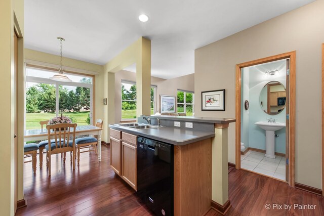937 Emerald Dr, Pingree Grove, IL 60140 - kitchen featuring dishwasher, dark wood-type flooring, decorative light fixtures, a kitchen island with sink, and plenty of natural light