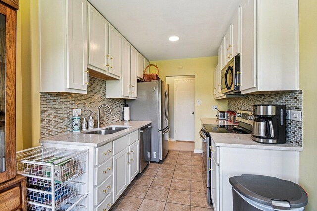 6833 N Kedzie Ave Unit 406, Chicago, IL 60645 - kitchen with stainless steel appliances, backsplash, light countertops, white cabinetry, and recessed lighting