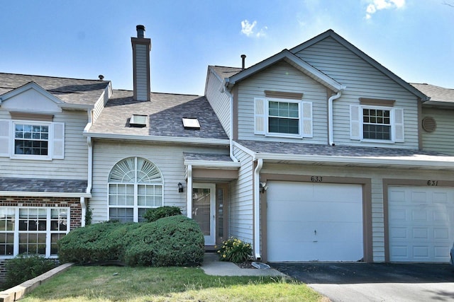 633 Ascot Ln, Streamwood, IL 60107 - view of property featuring asphalt driveway, a chimney, and an attached garage