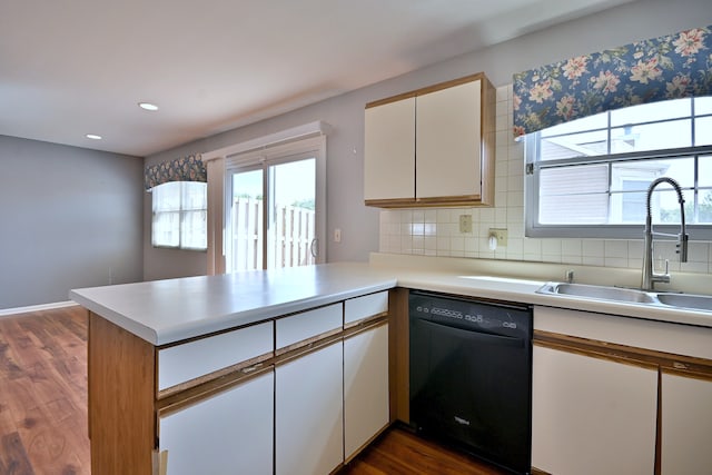 633 Ascot Ln, Streamwood, IL 60107 - kitchen featuring dishwasher, a peninsula, dark wood-type flooring, light countertops, and white cabinetry