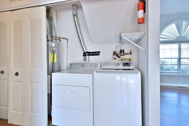 633 Ascot Ln, Streamwood, IL 60107 - washroom featuring washer and clothes dryer, water heater, and wood finished floors