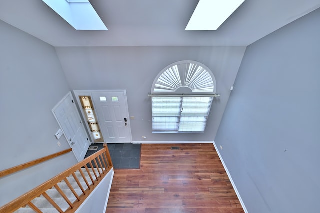 633 Ascot Ln, Streamwood, IL 60107 - foyer entrance with a skylight, vaulted ceiling, and wood finished floors