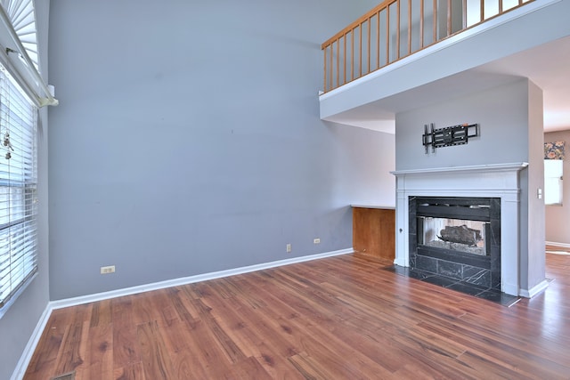 633 Ascot Ln, Streamwood, IL 60107 - unfurnished living room with a tiled fireplace and wood finished floors