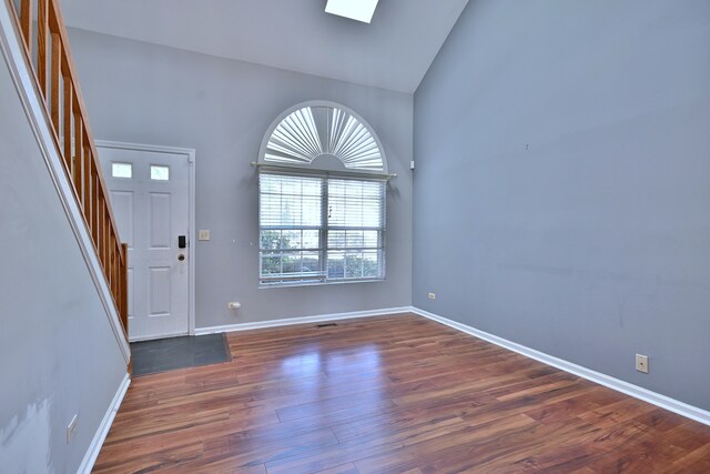 633 Ascot Ln, Streamwood, IL 60107 - entryway featuring high vaulted ceiling, wood finished floors, stairs, and a skylight