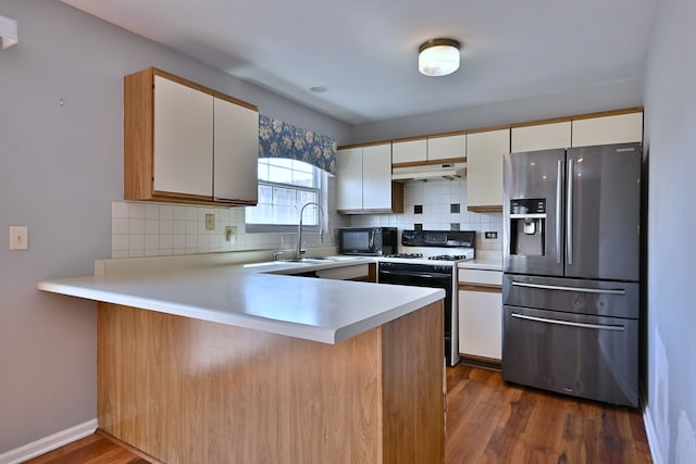 633 Ascot Ln, Streamwood, IL 60107 - kitchen with stainless steel fridge with ice dispenser, gas stove, a peninsula, under cabinet range hood, and light countertops