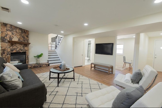 507 Wingate Dr, Schaumburg, IL 60193 - living area with stairway, light wood-type flooring, a stone fireplace, and recessed lighting