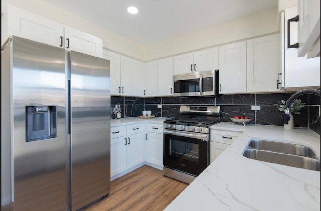 507 Wingate Dr, Schaumburg, IL 60193 - kitchen with stainless steel appliances, light wood-style floors, white cabinetry, light stone counters, and recessed lighting