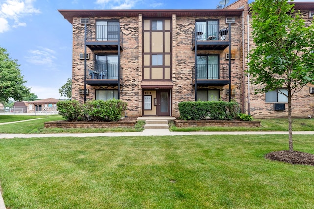 124 Klein Creek Ct Unit 5E, Carol Stream, IL 60188 - view of front facade with brick siding, a front yard, and a balcony