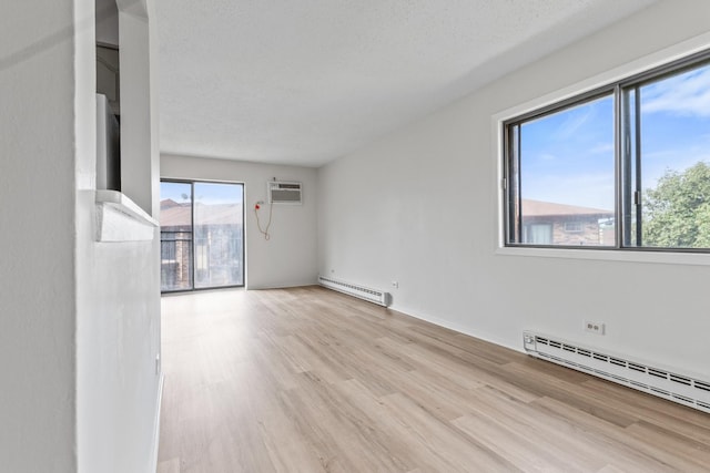 124 Klein Creek Ct Unit 5E, Carol Stream, IL 60188 - spare room with a baseboard heating unit, wood finished floors, and an AC wall unit