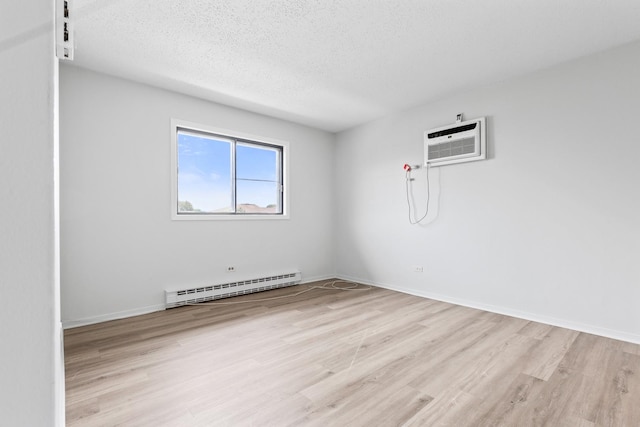 124 Klein Creek Ct Unit 5E, Carol Stream, IL 60188 - empty room featuring a baseboard radiator, a wall unit AC, light wood-style floors, and a textured ceiling