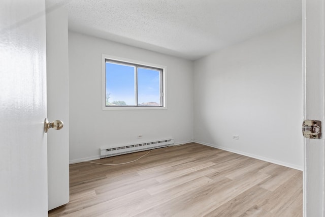 124 Klein Creek Ct Unit 5E, Carol Stream, IL 60188 - unfurnished room with a baseboard radiator, light wood-style flooring, and a textured ceiling