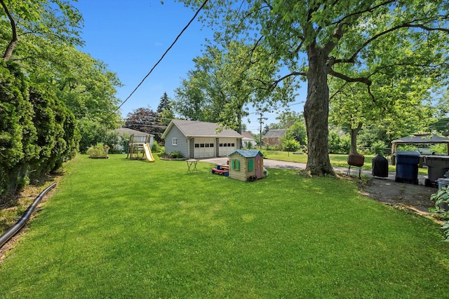 21207 Locust St, Matteson, IL 60443 - view of green lawn with a playground, an outdoor structure, and a detached garage